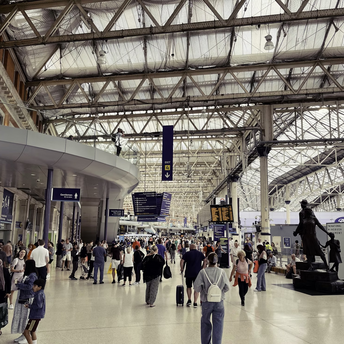 Crowded transit hub with travellers and departure boards