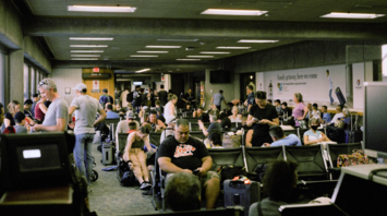 Crowded airport gate area with passengers waiting for boarding