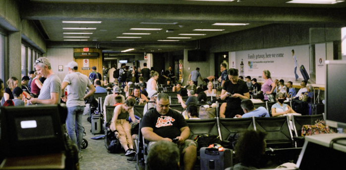 Crowded airport gate area with passengers waiting for boarding