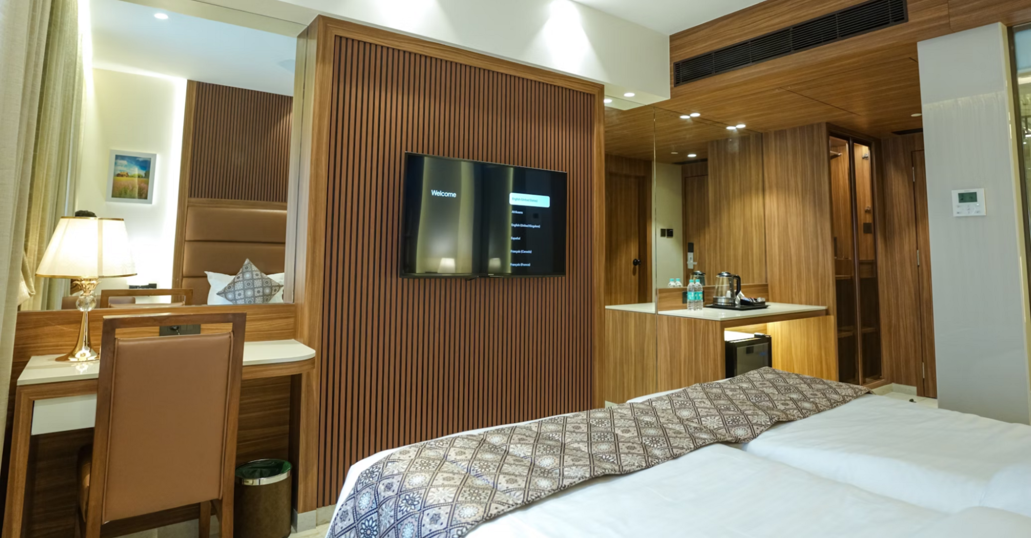 Modern guest room interior at Avani+ Barbarons with wood accents and workspace