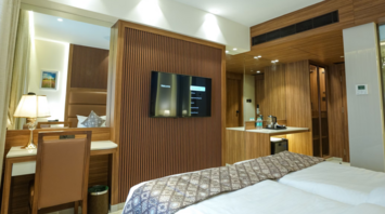 Modern guest room interior at Avani+ Barbarons with wood accents and workspace