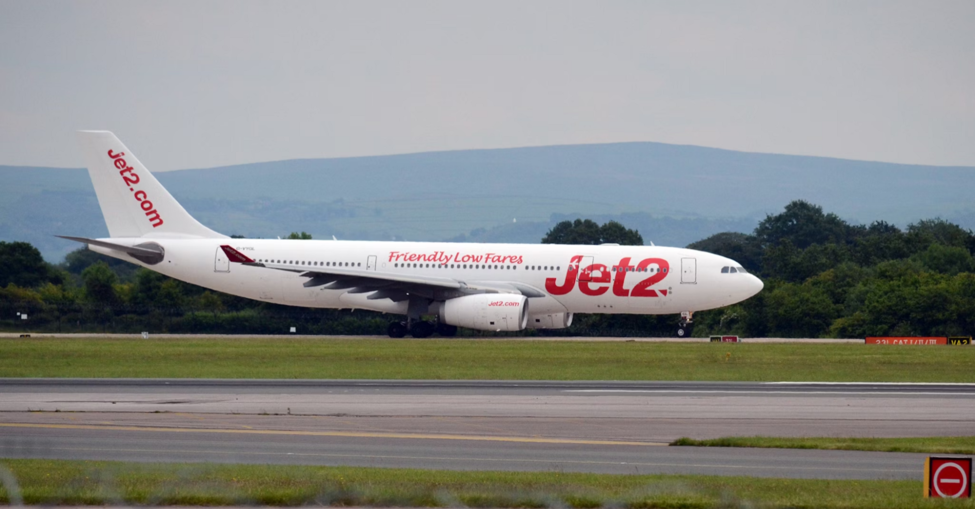 Jet2 airplane taxiing on runway at UK airport