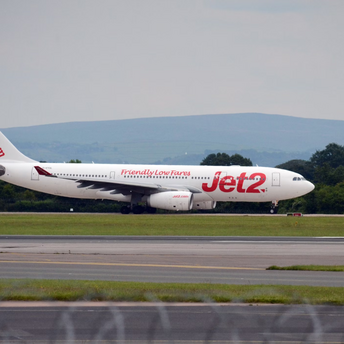 Jet2 airplane taxiing on runway at UK airport