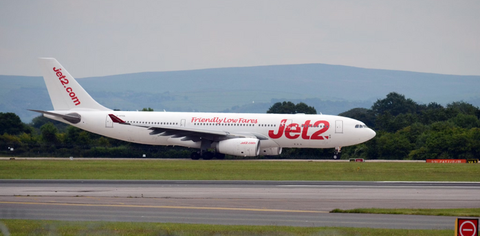 Jet2 airplane taxiing on runway at UK airport