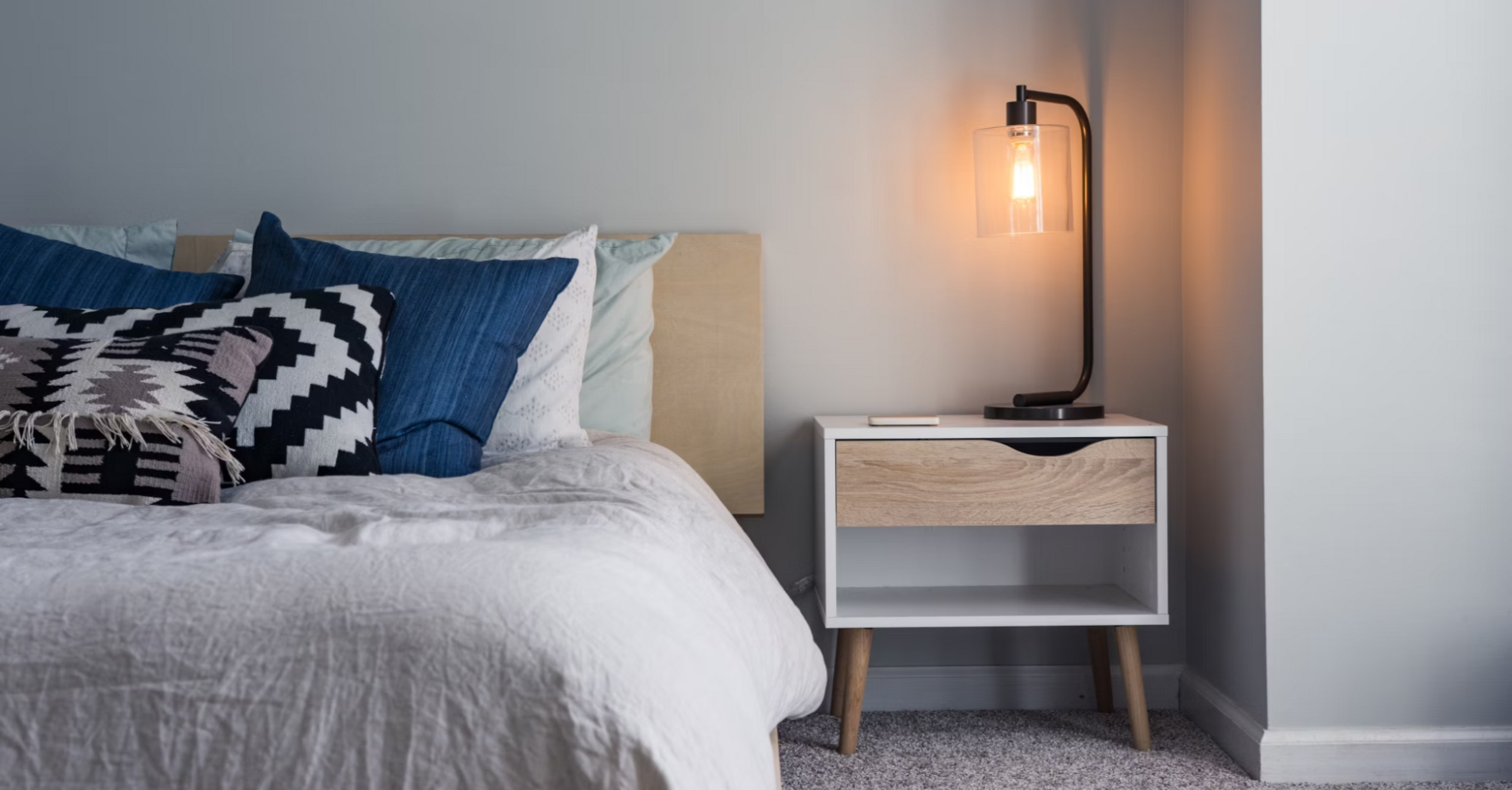Modern hotel bedroom with stylish lighting and cozy decor