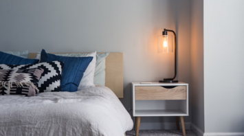 Modern hotel bedroom with stylish lighting and cozy decor