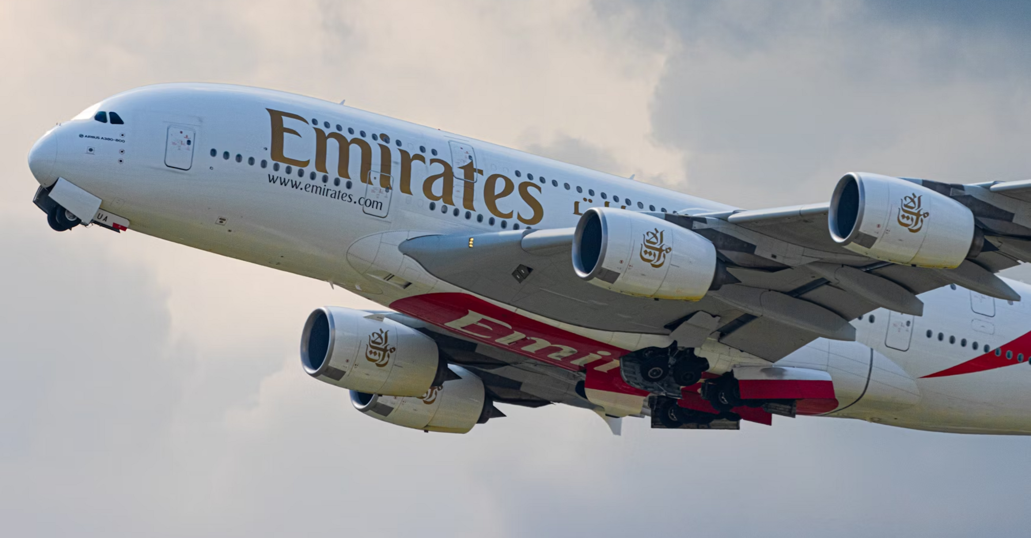 Emirates Airbus A380 taking off into cloudy sky