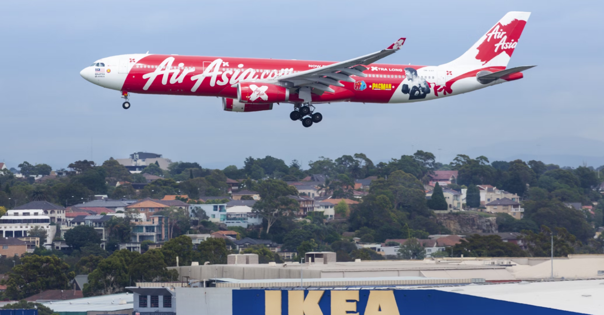 AirAsia aircraft in flight against a blue sky
