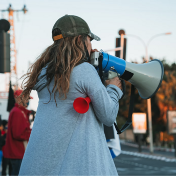 Woman using a megaphone during a public strike
