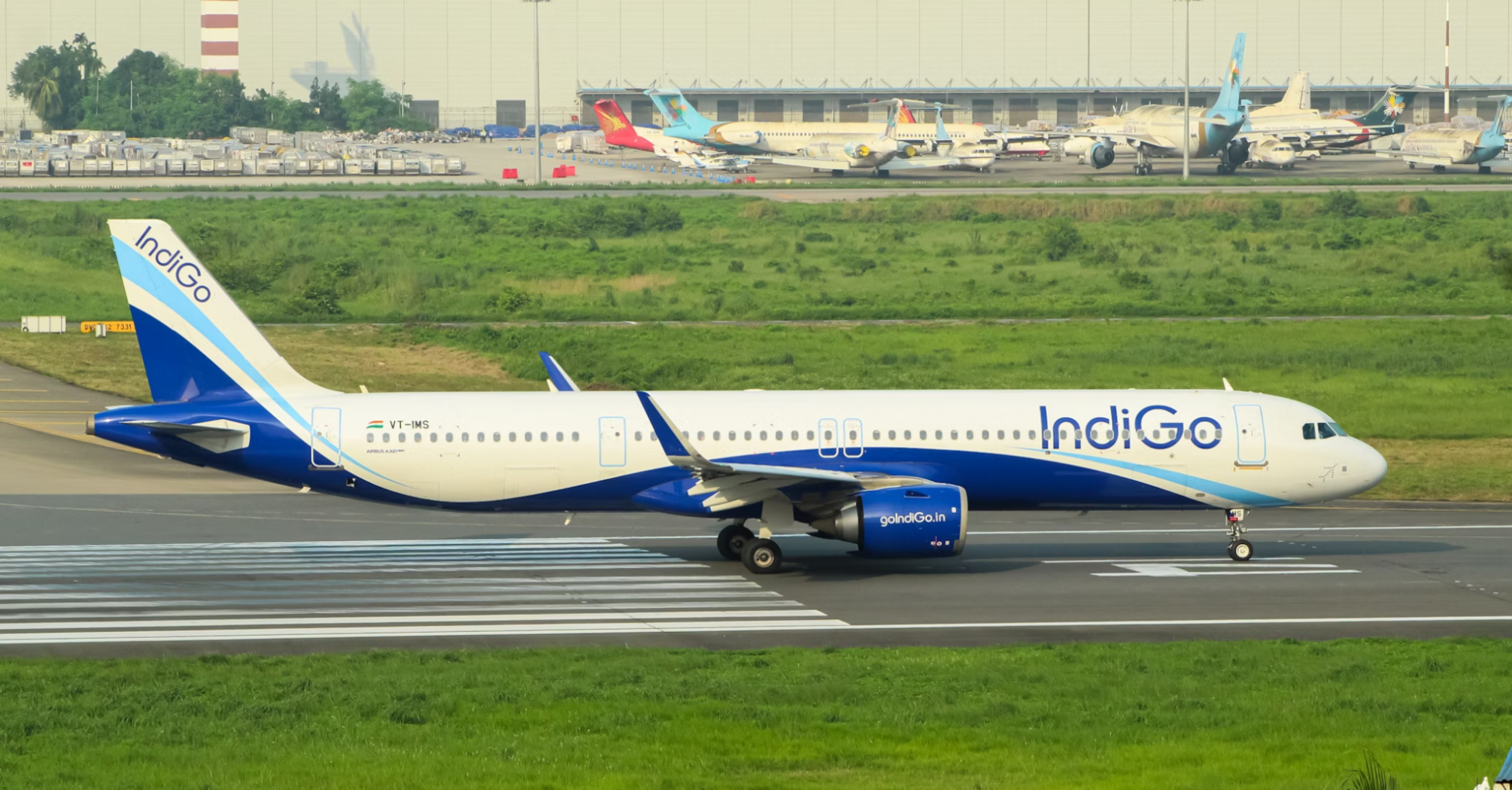 IndiGo aircraft taxiing on runway at an Indian airport