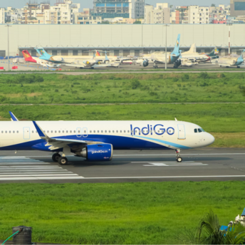IndiGo aircraft taxiing on runway at an Indian airport