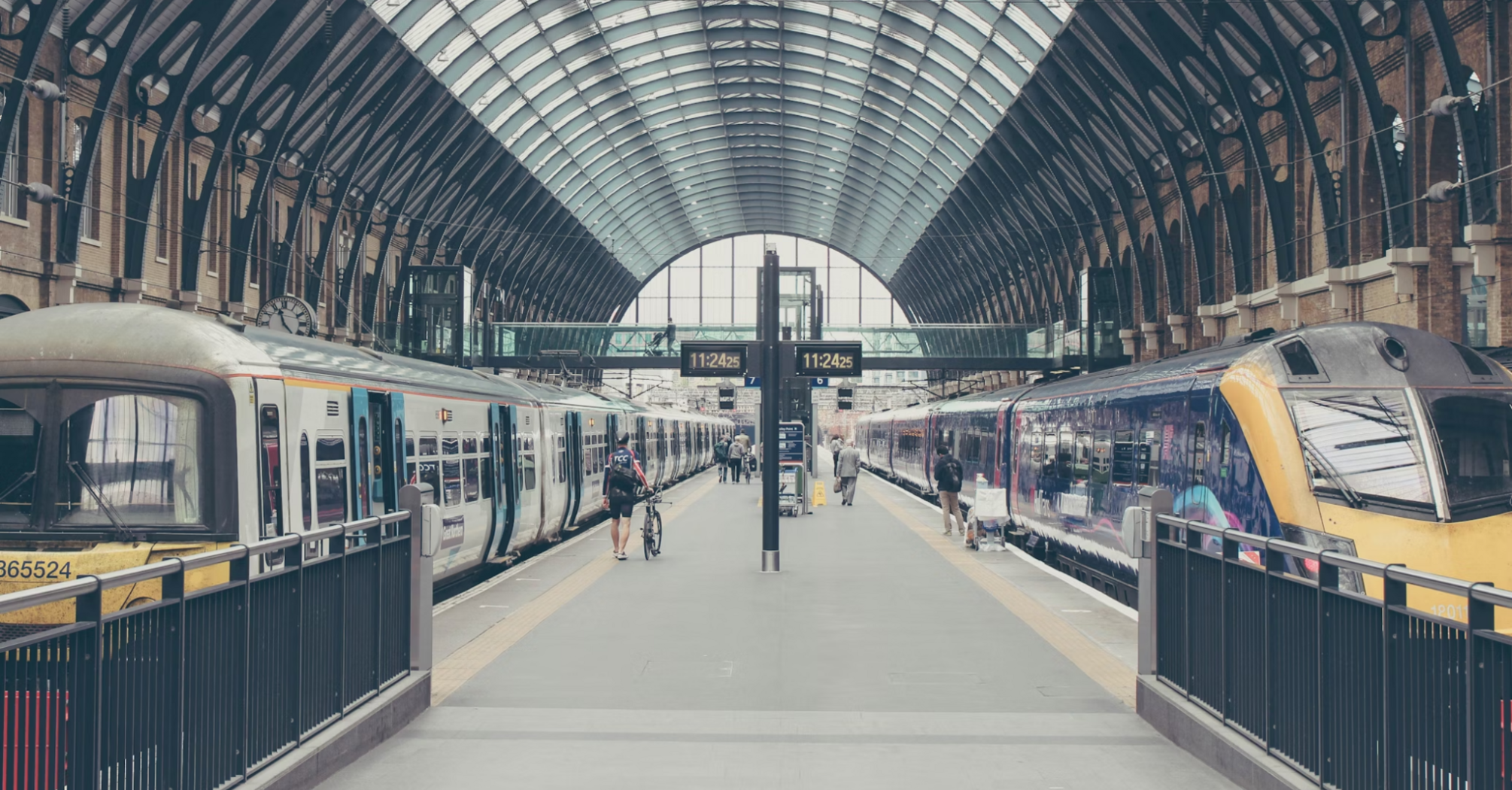 Trains at London's King’s Cross station under a glass roof