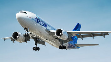 Air Transat aircraft approaching for landing under clear skies