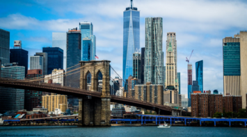 Brooklyn Bridge with Manhattan skyline in the background on a partly cloudy day