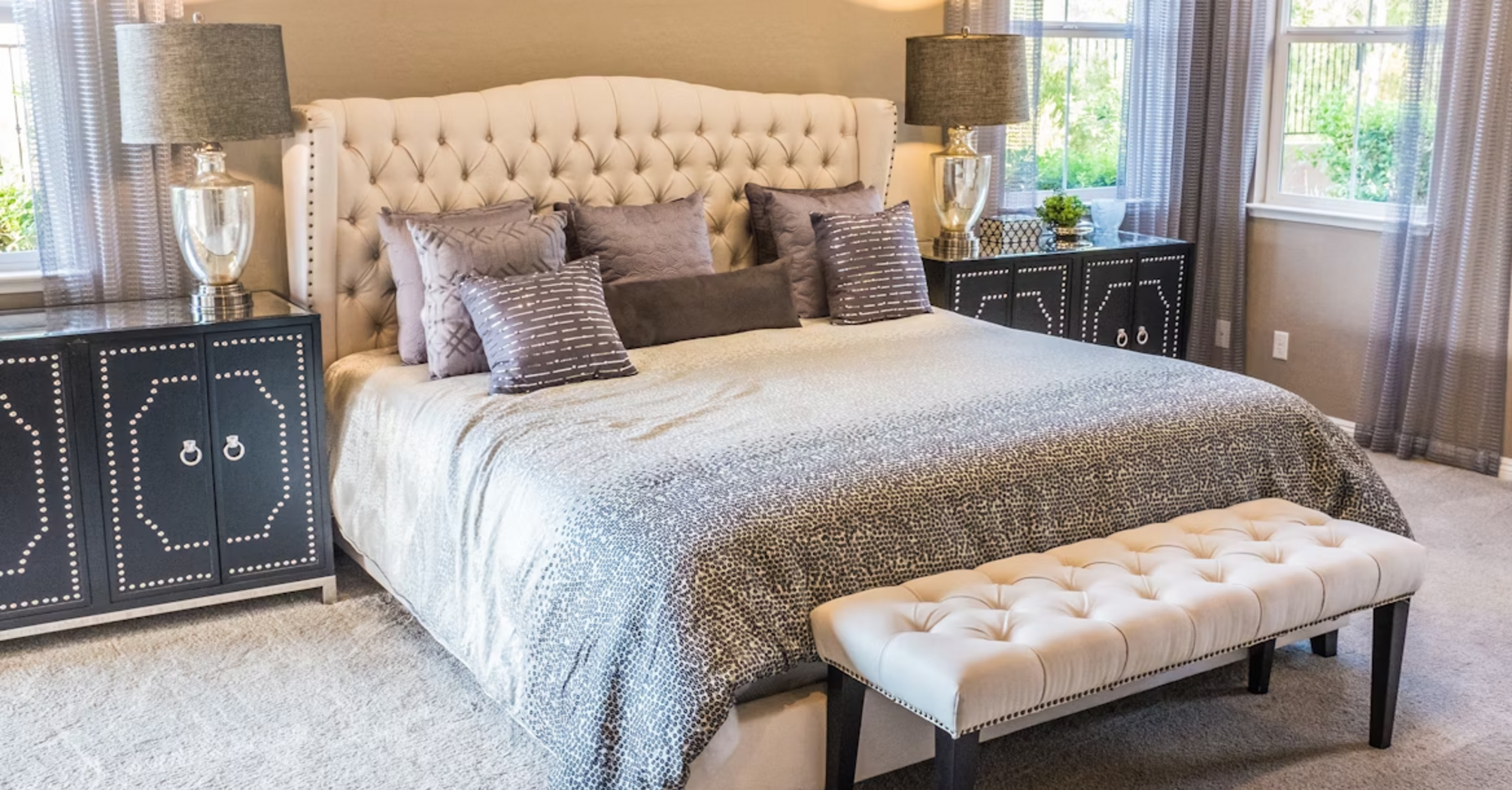 Interior of a modern bedroom with neutral tones and decorative pillows