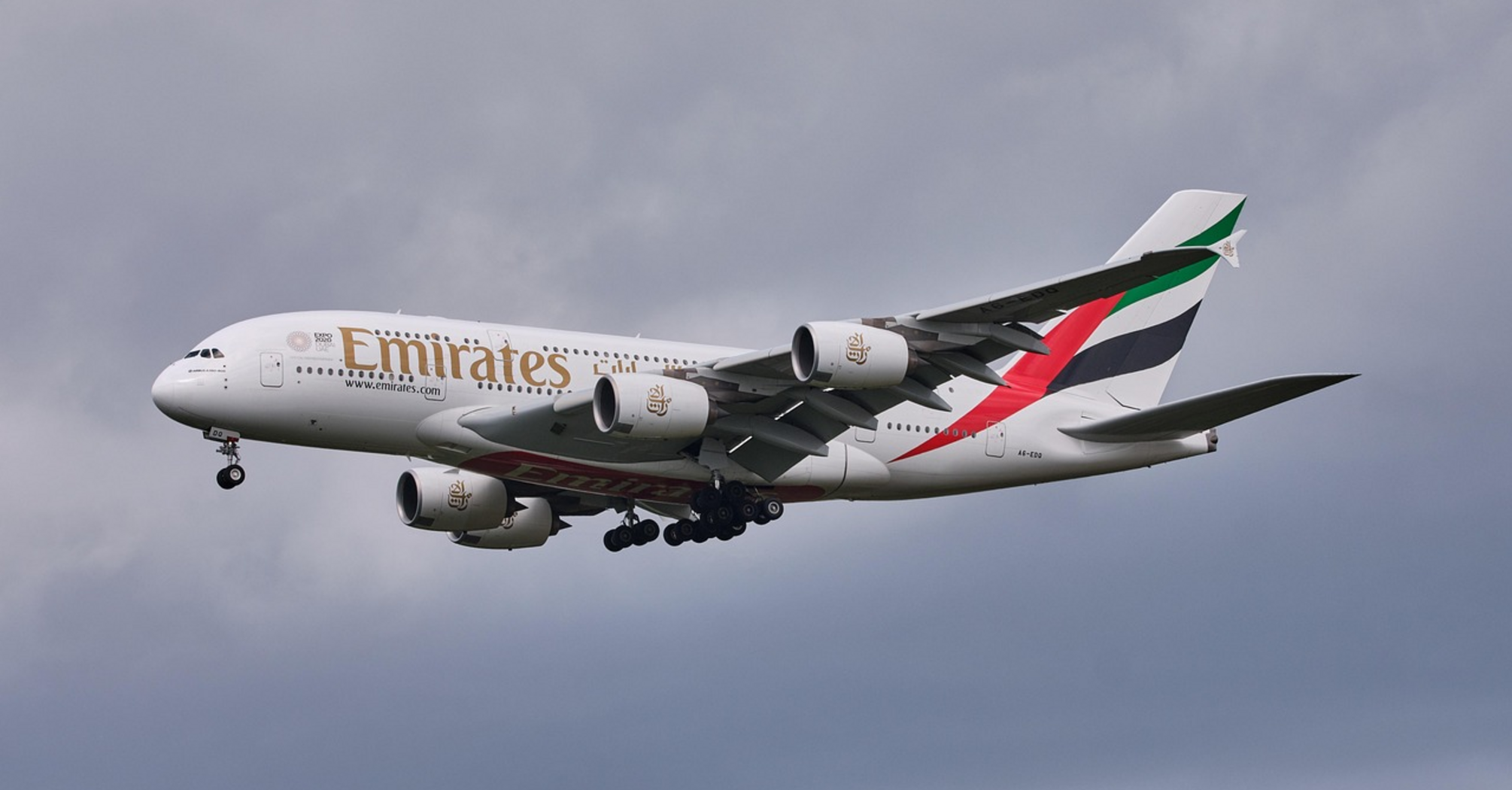 Emirates Airbus A380 flying against a cloudy sky