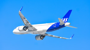 SAS aircraft in flight against clear blue sky