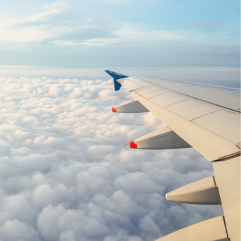 Air Corsica aircraft wing above the clouds during flight