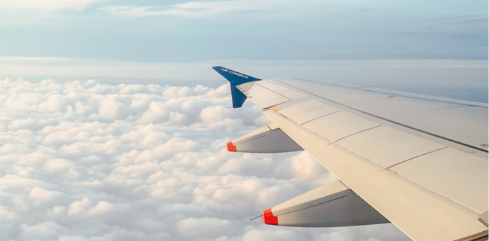 Air Corsica aircraft wing above the clouds during flight