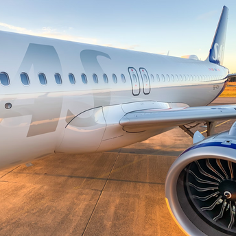 Close-up of a Scandinavian Airlines aircraft parked on the tarmac at sunset
