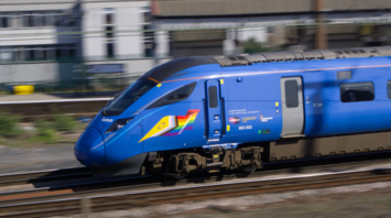 Electric Lumo train moving on railway tracks in the UK