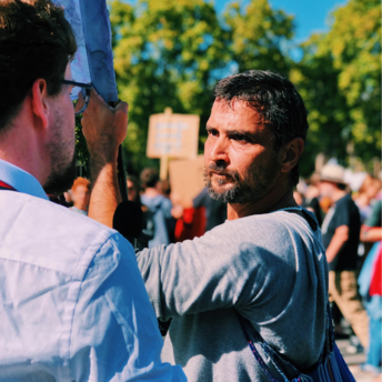 Man speaking to protester during strike demonstration