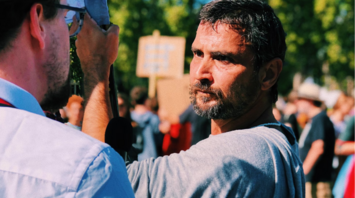 Man speaking to protester during strike demonstration
