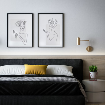 Modern hotel room with minimalistic decor and artwork above bed