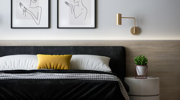 Modern hotel room with minimalistic decor and artwork above bed