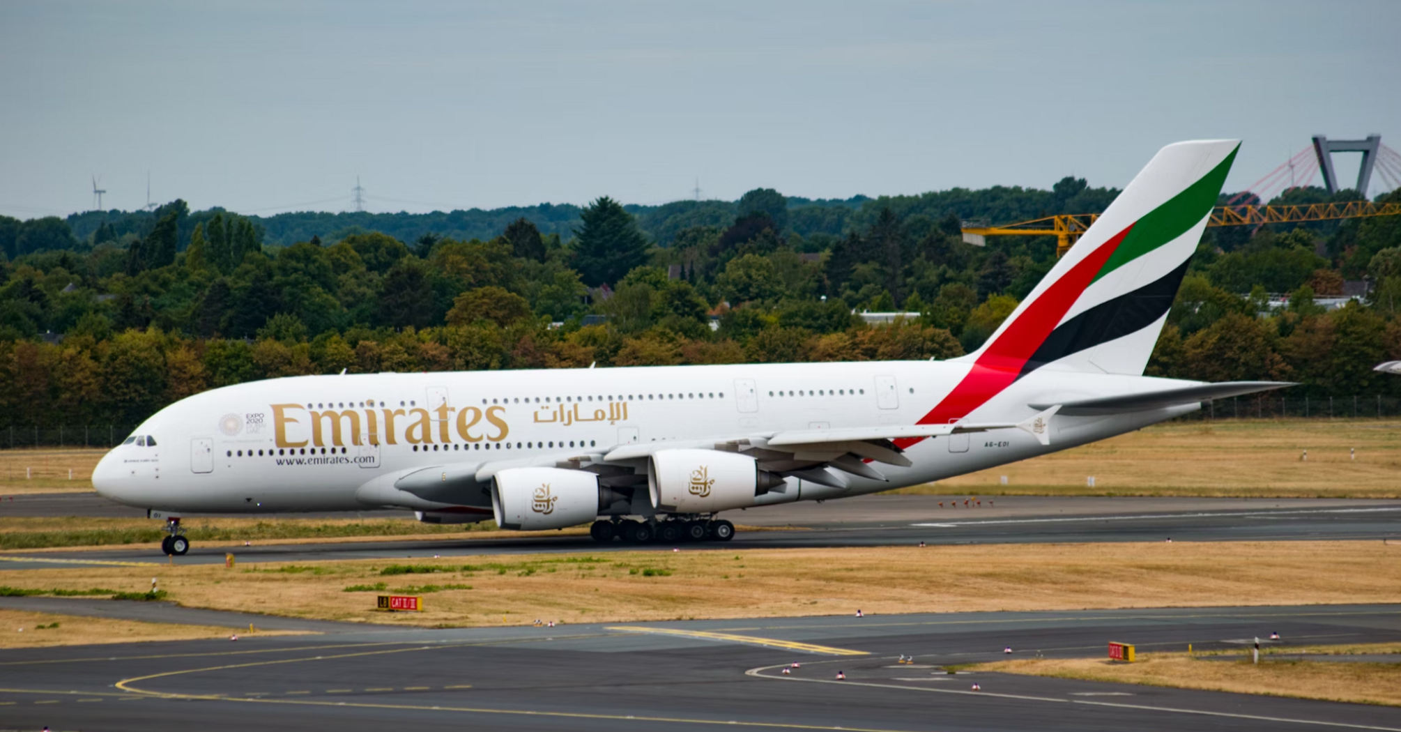 Emirates aircraft taxiing on airport runway
