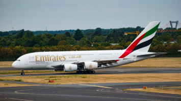 Emirates aircraft taxiing on airport runway