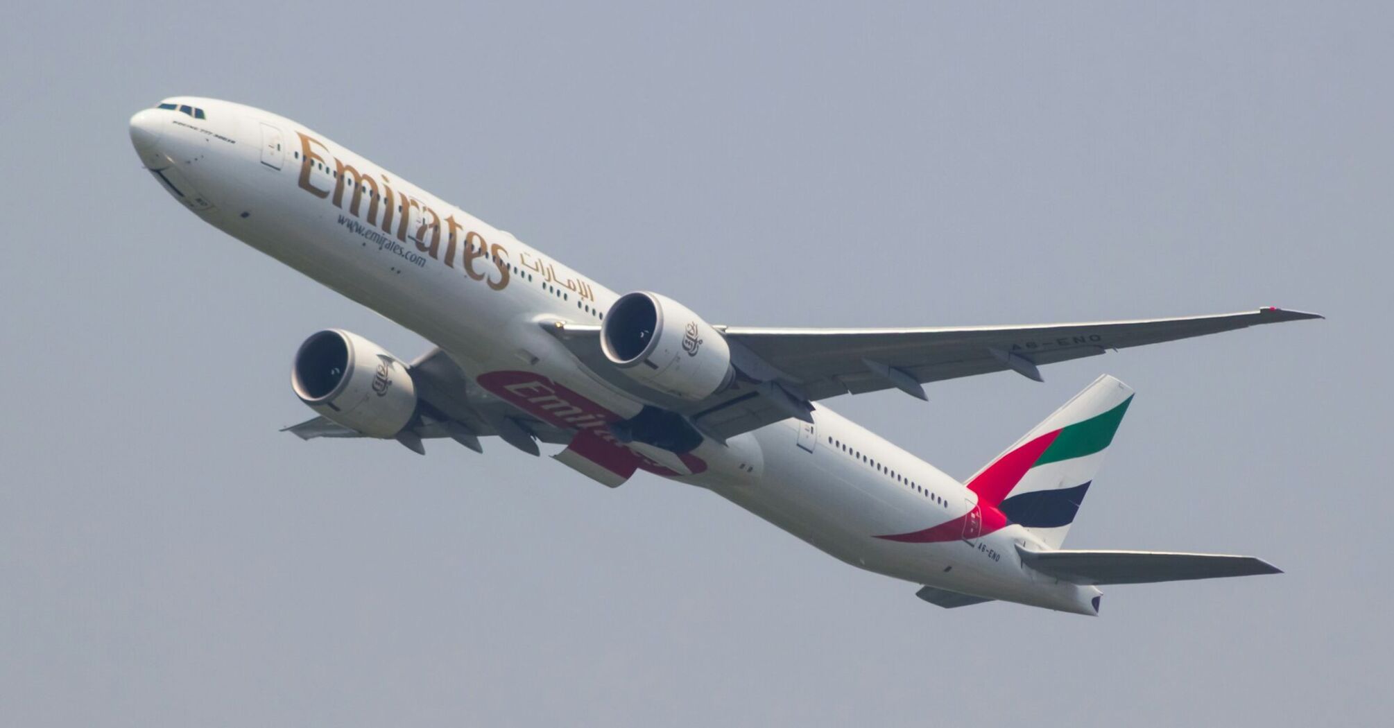 Emirates Boeing 777-300ER taking off against a clear sky