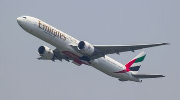 Emirates Boeing 777-300ER taking off against a clear sky