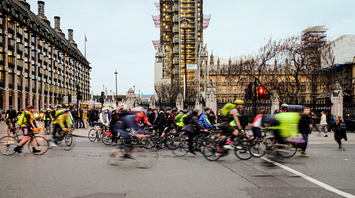 Cyclists riding through central London during a large group event