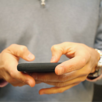 Person holding a smartphone and typing