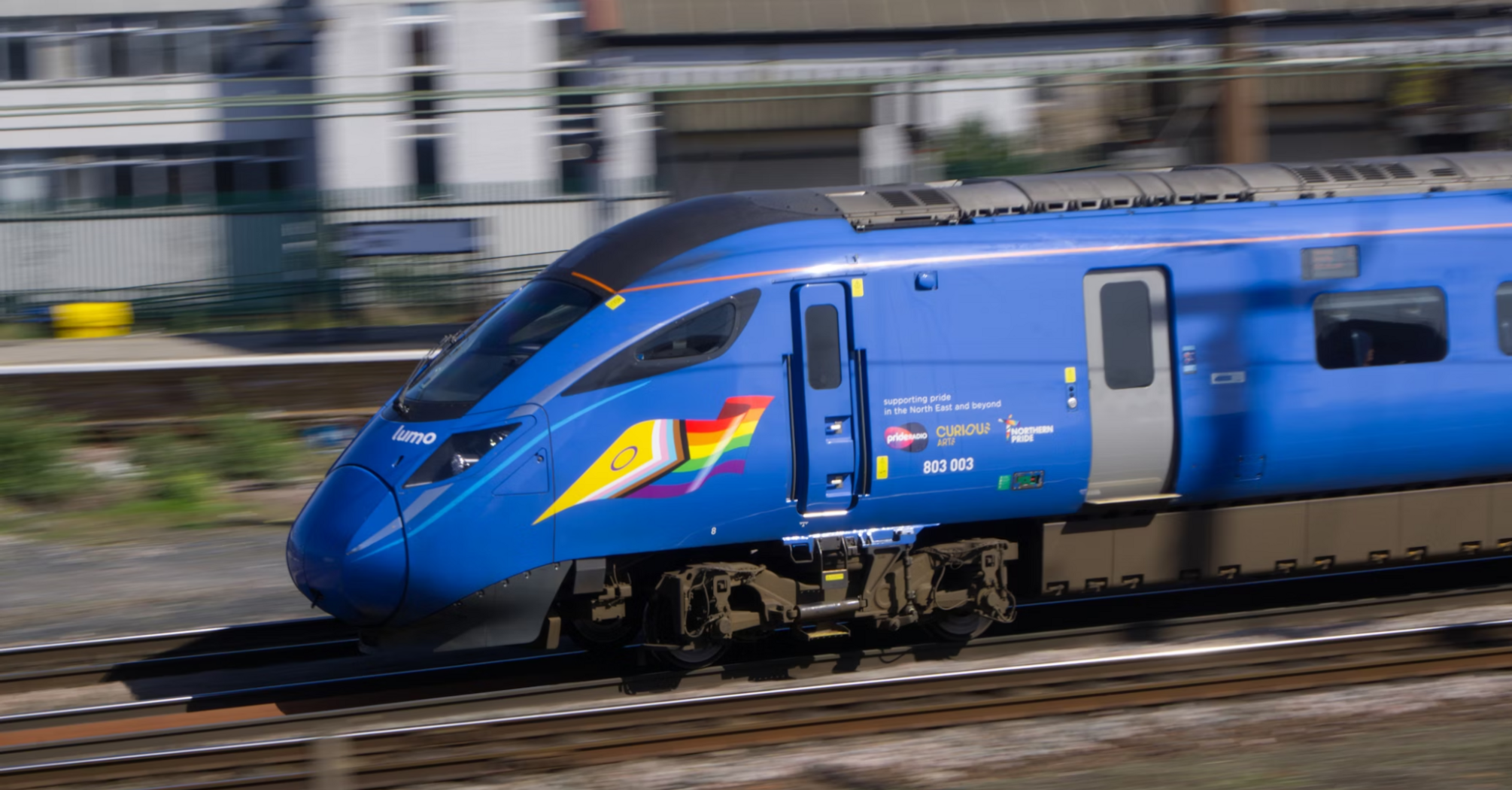High-speed Lumo train passing through an urban station