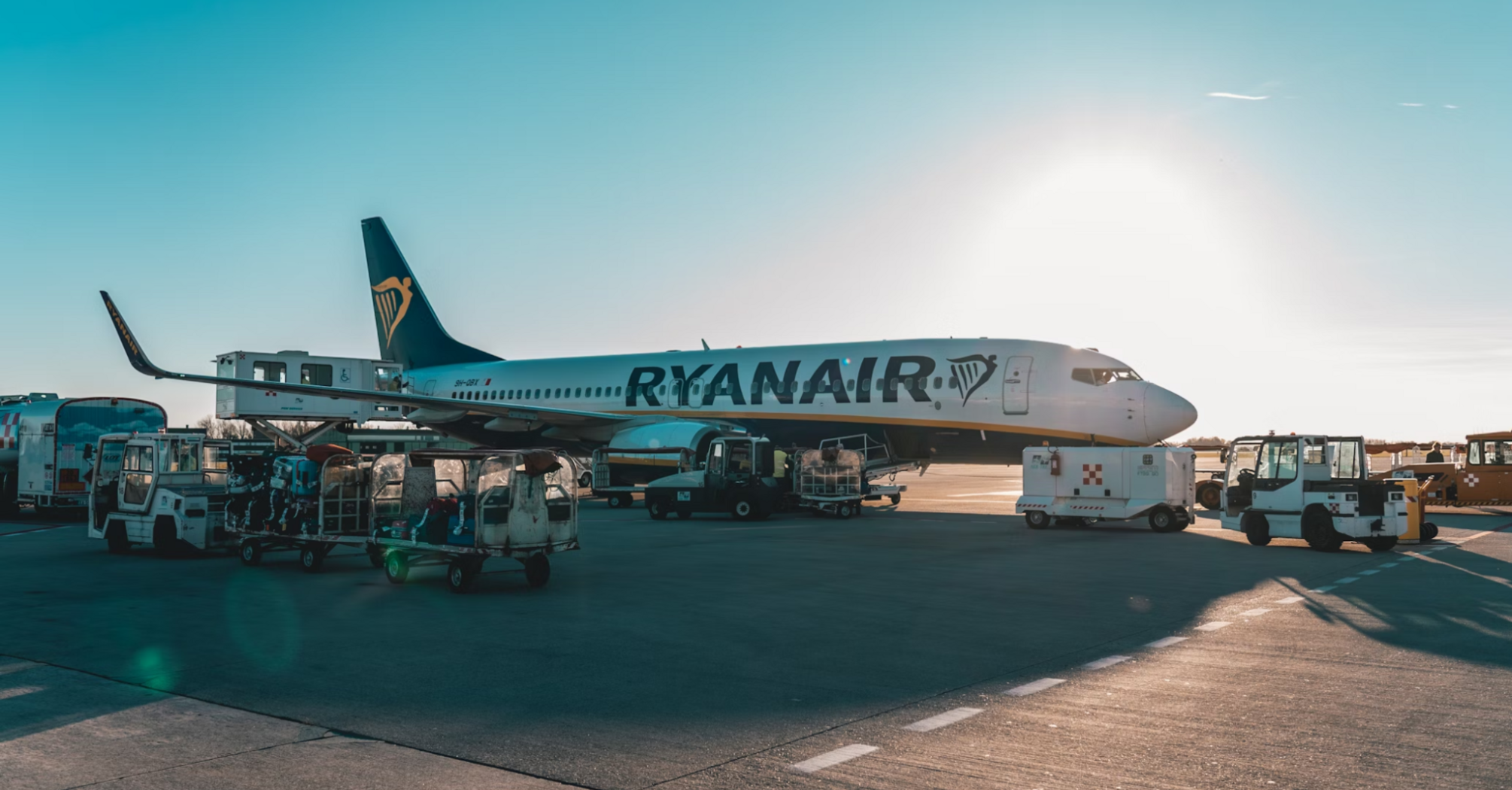 Ryanair aircraft on airport tarmac during ground handling at sunset