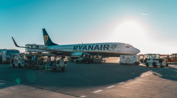 Ryanair aircraft on airport tarmac during ground handling at sunset
