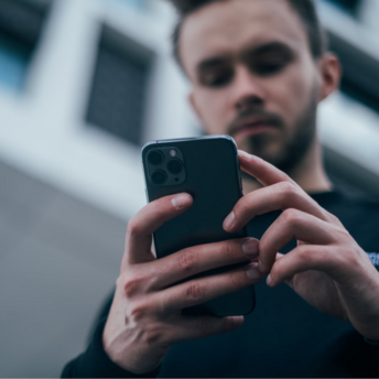 Man checking updates on a smartphone outdoors