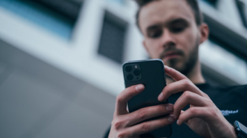 Man checking updates on a smartphone outdoors