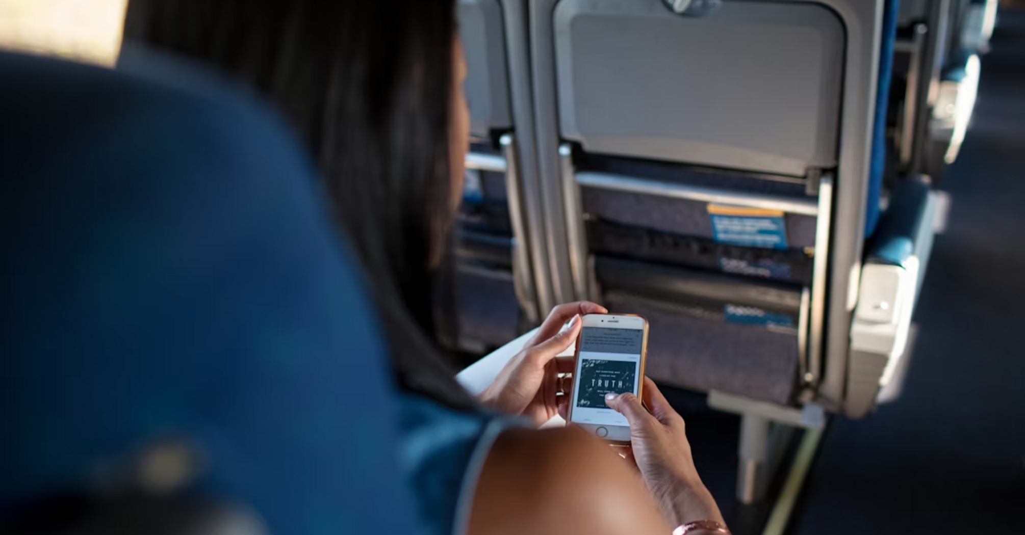 Passenger using smartphone during a flight