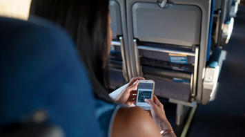 Passenger using smartphone during a flight