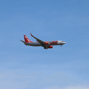 Jet2.com airplane flying against a clear blue sky