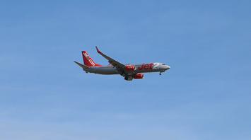 Jet2.com airplane flying against a clear blue sky