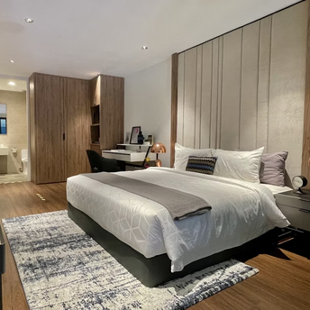 Modern hotel room with bed, desk and en-suite bathroom