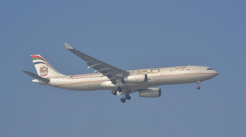Etihad Airways aircraft approaching for landing under clear skies