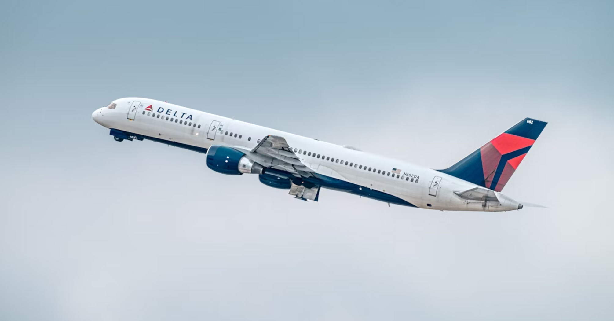 Delta airplane in flight against clear sky