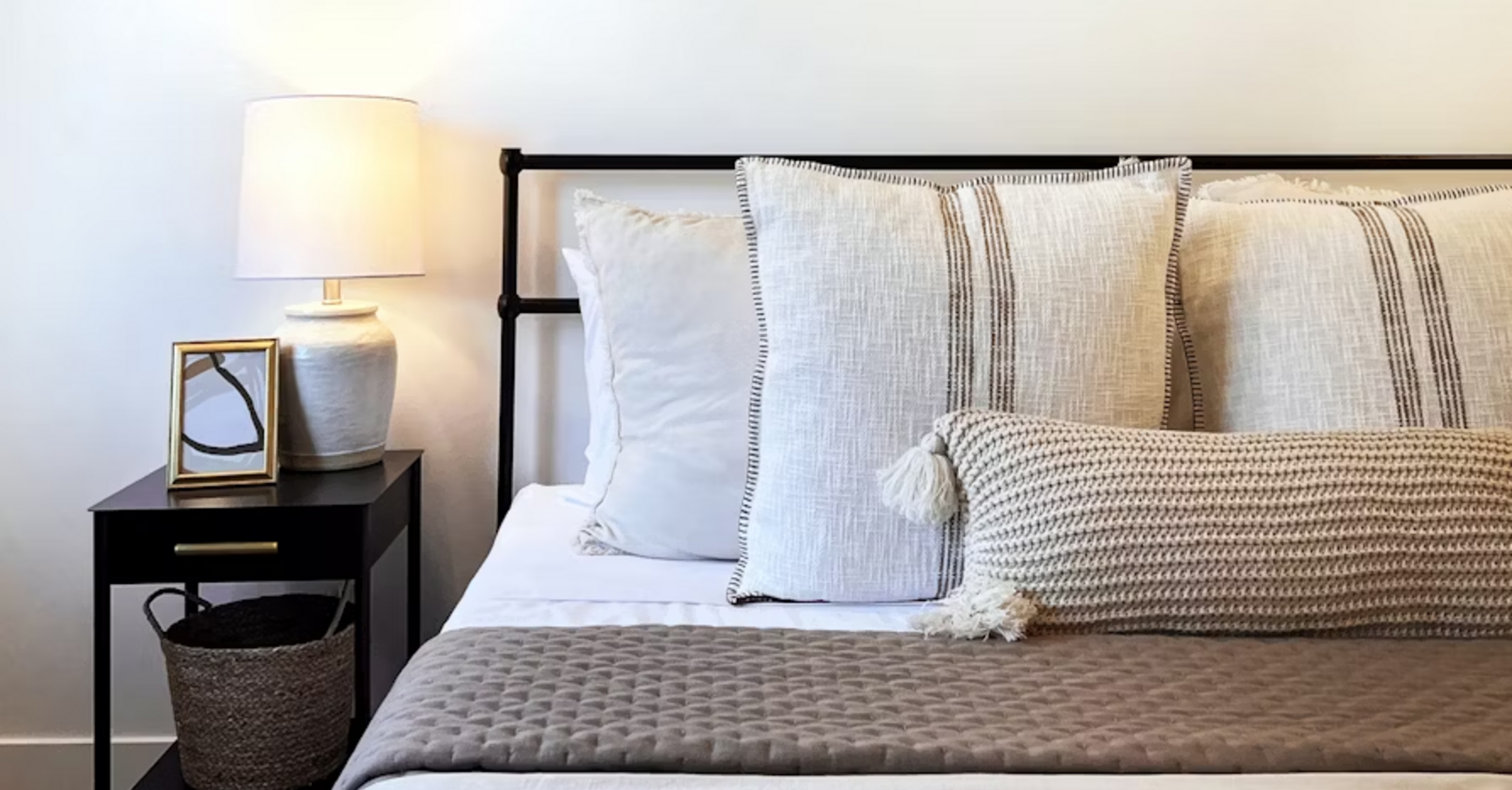 Cozy modern bedroom with neutral decor and soft lighting
