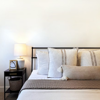 Cozy modern bedroom with neutral decor and soft lighting