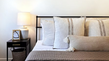 Cozy modern bedroom with neutral decor and soft lighting